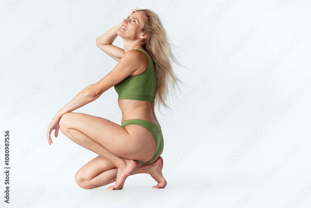 Full size photo of gorgeous mature blonde lady posing squat wear khaki lingerie isolated white background no retouch Full size photo of gorgeous mature blonde lady posing squat wear khaki lingerie isolated white background no retouch