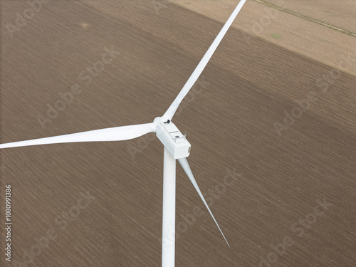 Wind turbine Engineer work on Top of Wind Turbine, maintenance service. The EU Green Deal and Zero Carbon Footprint