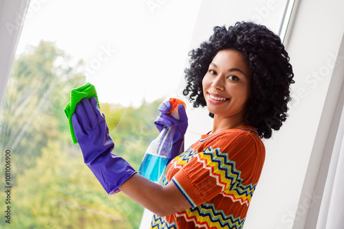 Profile portrait of pretty young girl spray rug clean wipe window glass wear t-shirt free time modern interior flat indoors photo