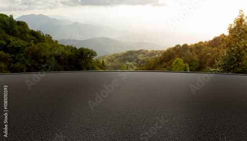 Fototapeta Naklejka Na Ścianę i Meble -  Asphalt parking lot or road with mountain background in morning or evening, backdrop for product display, black rough surface, cars, technology, modern equipment, surface for automotive showroom.