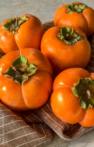 Close-up of several ripe persimmons. Shot on mobile device.