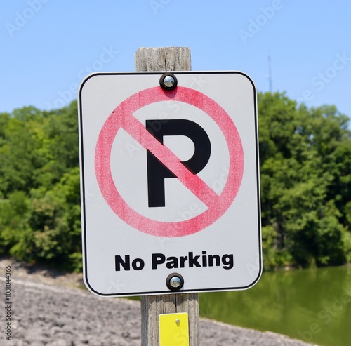 A close view of the no parking sign on the side of the road. photo