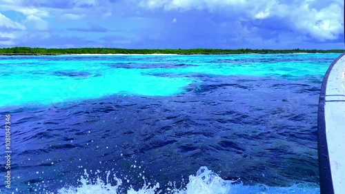 Scenic Boat Ride Along the Coastline of the Indian Ocean: Vibrant Turquoise Waters, Rolling Waves, and Stunning Shoreline Views from a Unique Perspective