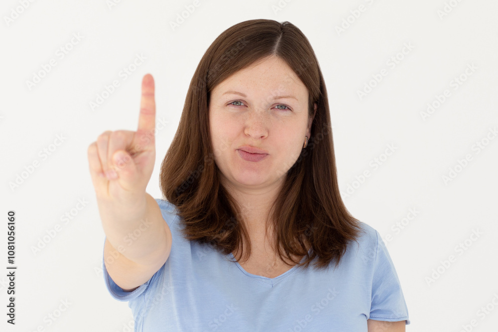 Portrait of young woman making stop sign with finger in front of the camera. Portrait of young woman making stop sign with finger in front of the camera.