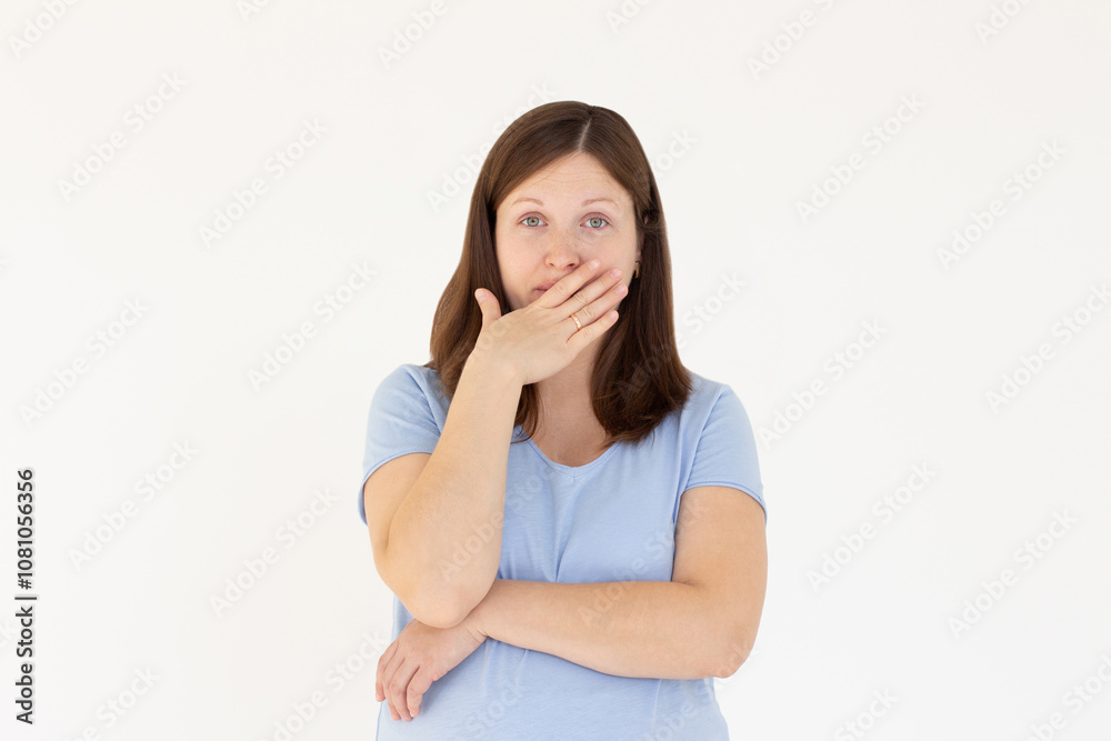 Happy woman closing her mouth with hand going to see surprise prepared by husband standing and smiling in anticipation for something wonderful. Young lady covering mouth with hands Happy woman closing her mouth with hand going to see surprise prepared by husband standing and smiling in anticipation for something wonderful. Young lady covering mouth with hands