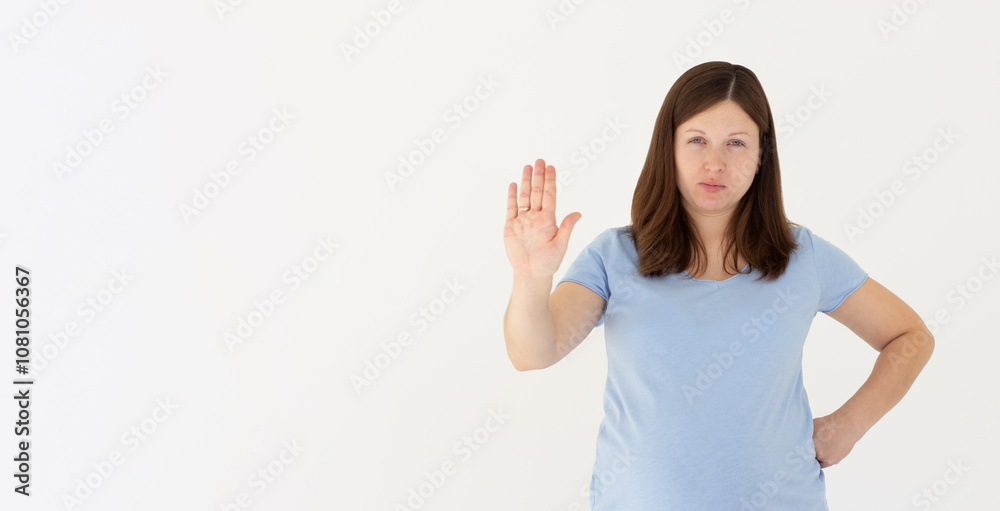 Portrait of young woman making stop sign in front of the camera. Portrait of young woman making stop sign in front of the camera.