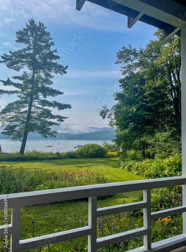 view from lake house porch in the Adirondacks with garden and clear skies 