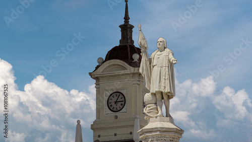 Monument to explorer Christopher Columbus and tower with watch on the Columbus square timelapse hyperlapse.