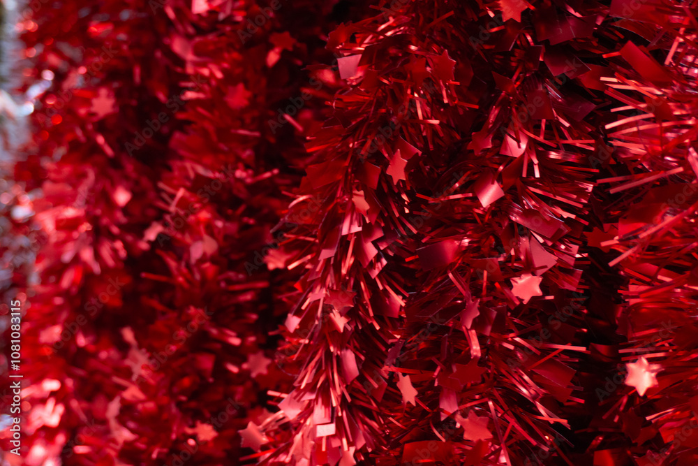 Glittering texture of red tinsel with deep tones, creating a sense of celebration and coziness. Shiny strands emit a bright glow, making the decor bold and festive. Glittering texture of red tinsel with deep tones, creating a sense of celebration and coziness. Shiny strands emit a bright glow, making the decor bold and festive.