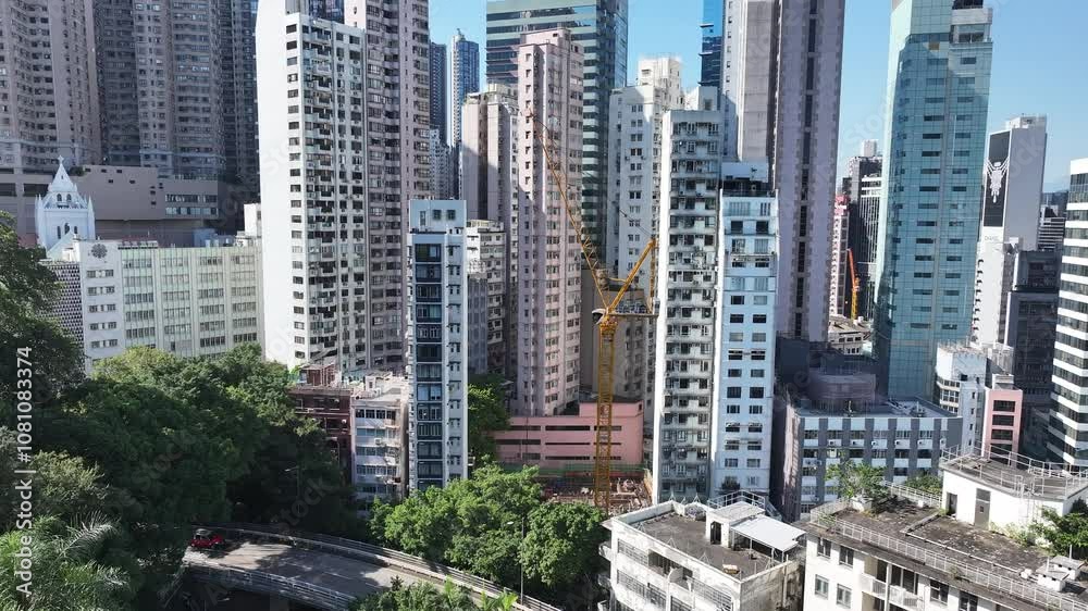 Skyview of Hong Kong Central Sheung Wan where towering skyscrapers rise amidst narrow spaces. Witness the intricate construction techniques used to build on steep slopes in this vibrant urban Skyview of Hong Kong Central Sheung Wan where towering skyscrapers rise amidst narrow spaces. Witness the intricate construction techniques used to build on steep slopes in this vibrant urban