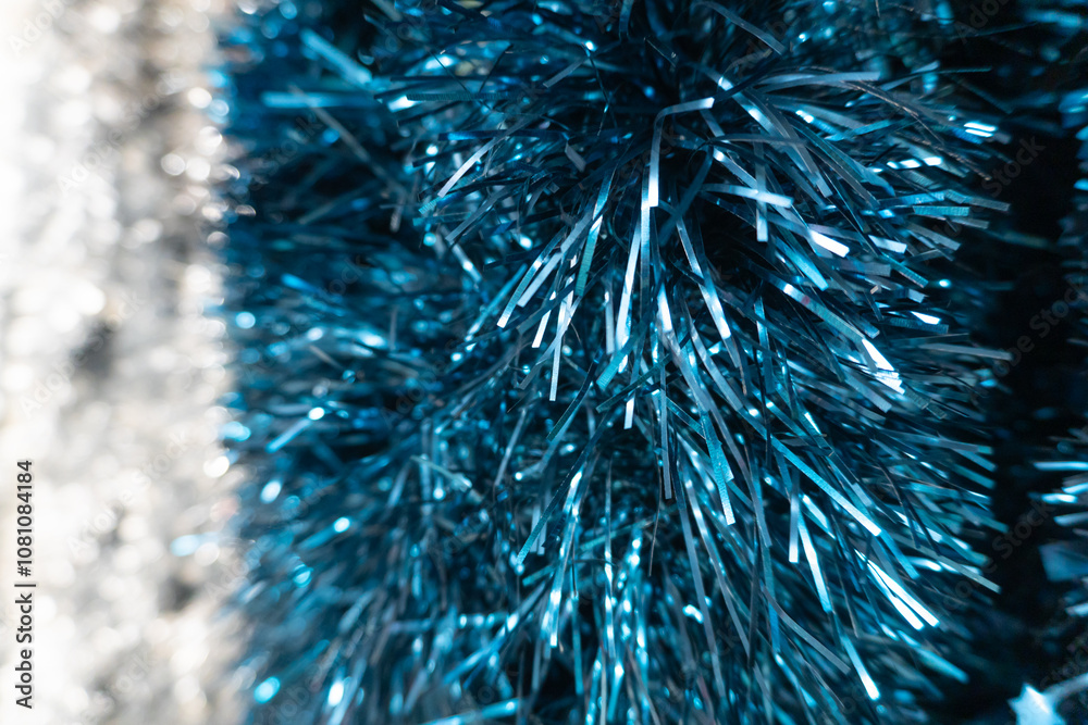 Close-up of sparkling blue tinsel with a dense texture of metallic strands gleaming under the light. The cool blue shade pairs beautifully with winter holidays, creating a fresh and luminous feel. Close-up of sparkling blue tinsel with a dense texture of metallic strands gleaming under the light. The cool blue shade pairs beautifully with winter holidays, creating a fresh and luminous feel.