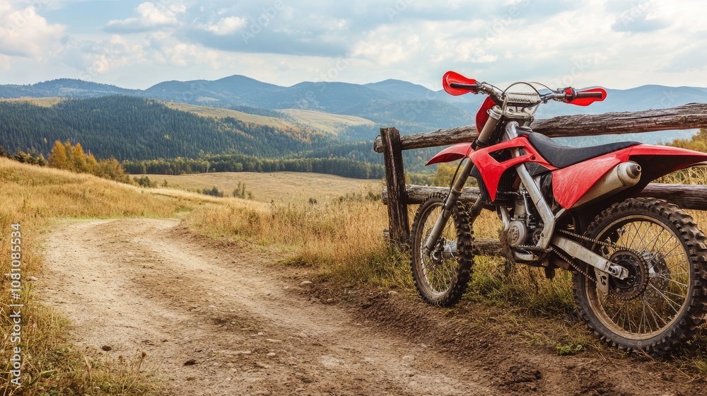 Scenic View of a Red Dirt Bike Parked by a Rustic Fence Overlooking a Beautiful Mountain Landscape Under a Dramatic Sky with Rolling Hills Scenic View of a Red Dirt Bike Parked by a Rustic Fence Overlooking a Beautiful Mountain Landscape Under a Dramatic Sky with Rolling Hills