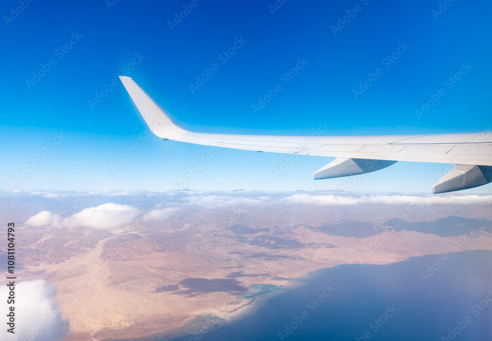 View from the airplane window of the mountains and sea resort with corals in Egypt, Sharm El Sheikh.Flight View from the airplane window of the mountains and sea resort with corals in Egypt, Sharm El Sheikh.Flight