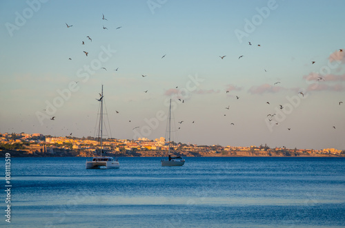 Obraz na płótnie Colored fishing boats near coast of old town Cascais, Portugal, at sunset in summer day w salonie