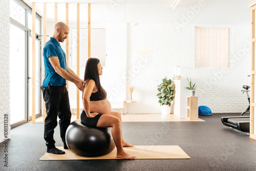 Pregnant Chinese Woman Practicing Relaxation Techniques With a Partner in a Serene Wellness Studio During a Session