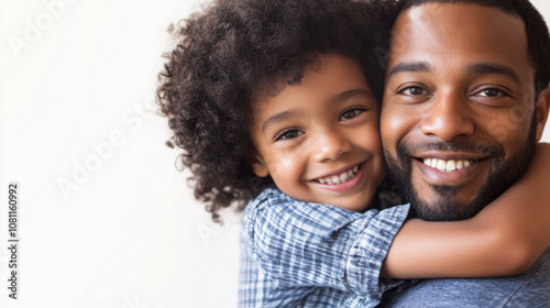 Joyful bonding moment: child embracing father in heartfelt studio portrait