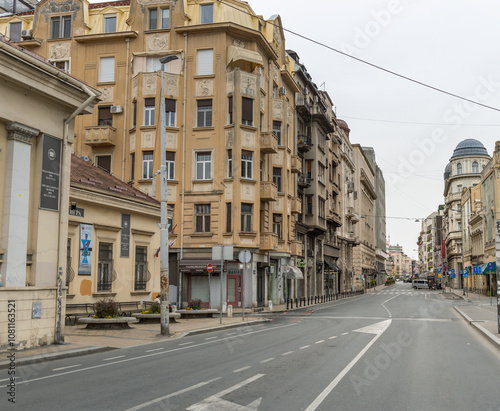 Quiet street with a few buildings and a few cars