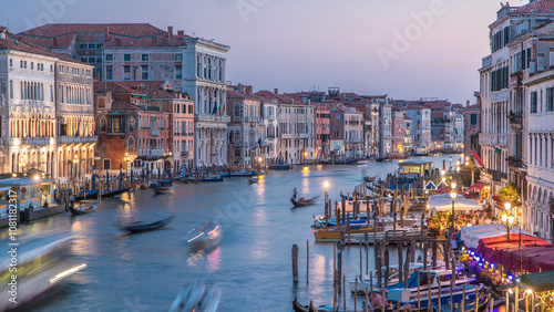 Grand Canal in Venice, Italy day to night timelapse. Gondolas and city lights from Rialto Bridge. photo