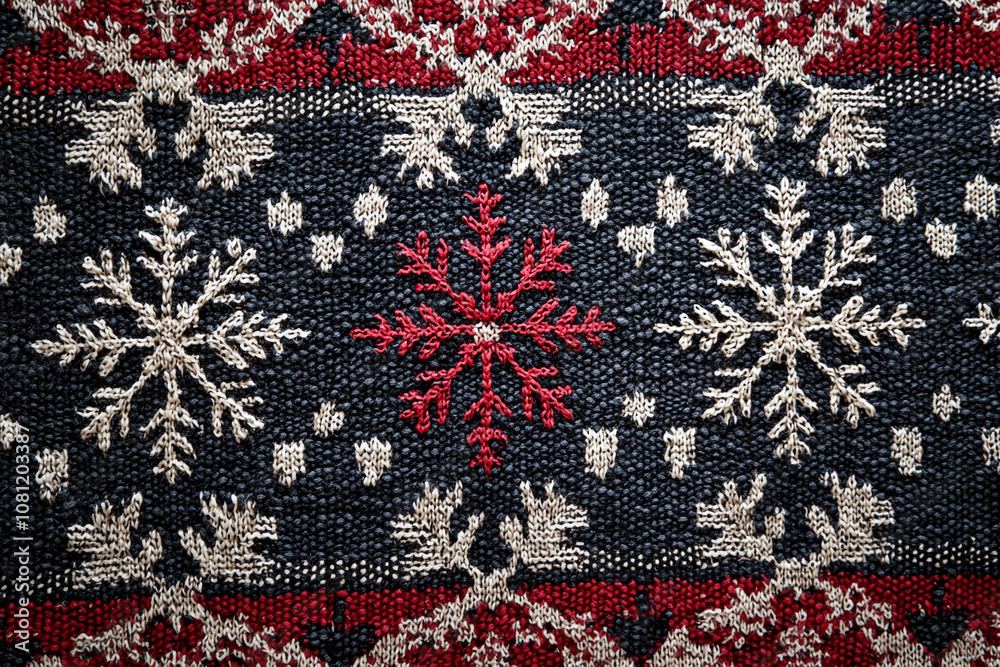 Traditional nordic winter pattern with geometric snowflakes on textile. Traditional nordic winter pattern with geometric snowflakes on textile.