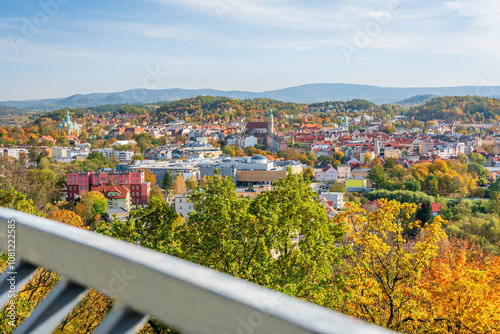 Jelenia Gora, autumn landscape of the city center and the Karkonosze Mountains. View of the city buildings from the Grzybek observation tower on Krzywousty Hill, sunny autumn day. photo