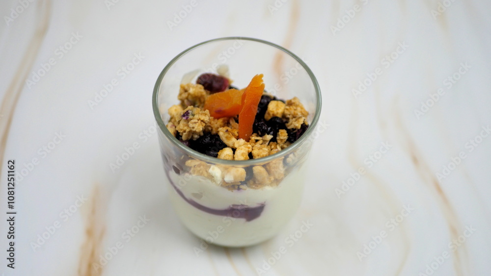 Yogurt with granola, forest fruits and dried apricots