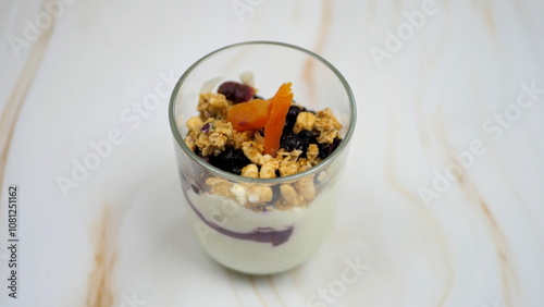 Yogurt with granola, forest fruits and dried apricots