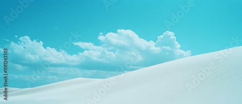 Pristine white sand dunes rise under fluffy clouds in a bright blue sky, capturing serene beauty and tranquility in a minimalist landscape. photo