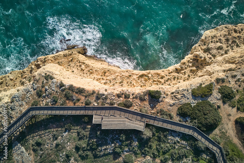 Top-down view of the wooden boardwalk and viewpoint on the top of the cliff in Carvoeiro