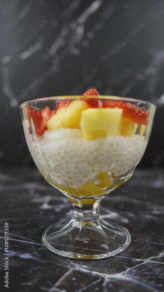 Dessert of tapioca balls with pineapple and mango in an ice cream cup Dessert of tapioca balls with pineapple and mango in an ice cream cup