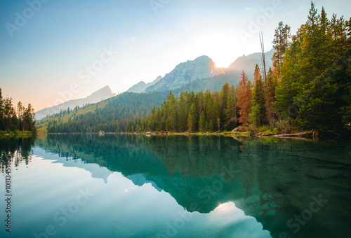 Reflections in Leigh Lake On A Still Summer Evening in Grand Teton National Park photo