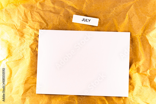 blank sheet of paper on the yellow background blank sheet of plans for meetings and events for the month july