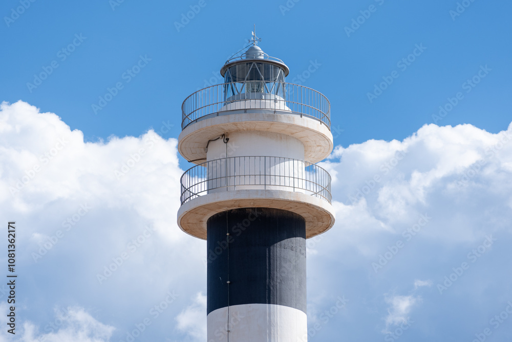 close-up of a lighthouse with a background of clouds close-up of a lighthouse with a background of clouds