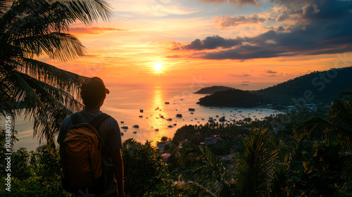 Man watching sunset over a tropical bay. photo