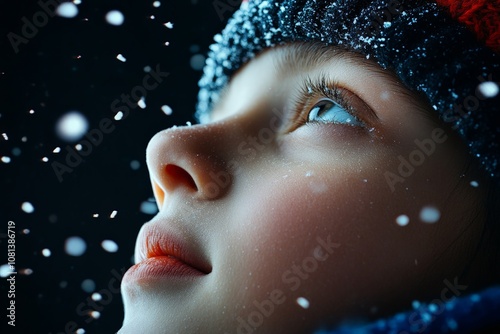 A close-up of a child's face turned skyward, snowflakes gently falling around, evokes a sense of wonder and contemplation in the soft dusk light. photo