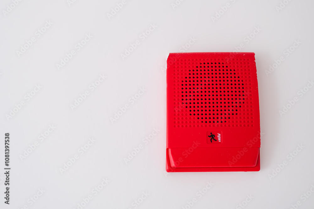 red fire alarm speaker mounted on a white wall, designed to alert occupants during emergencies with a visual and auditory signal for enhanced safety and quick evacuation. red fire alarm speaker mounted on a white wall, designed to alert occupants during emergencies with a visual and auditory signal for enhanced safety and quick evacuation.