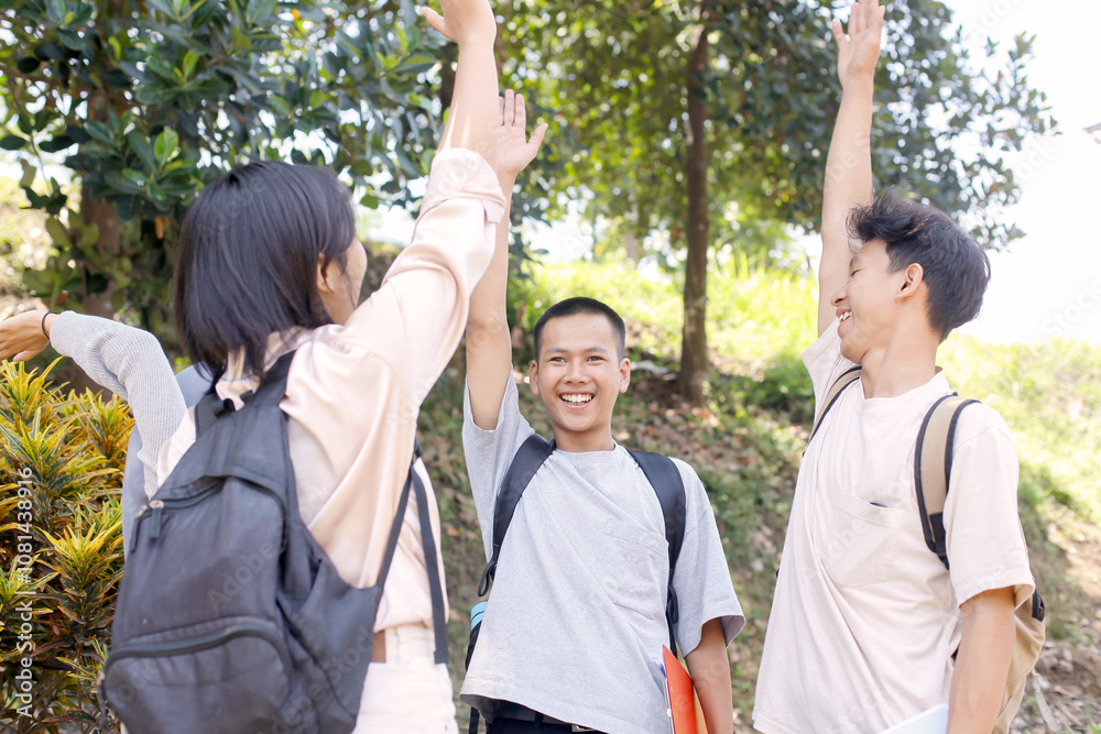 Multiethnic Group Of Asian Students Raising Hands While Learning Outdoor Together Multiethnic Group Of Asian Students Raising Hands While Learning Outdoor Together