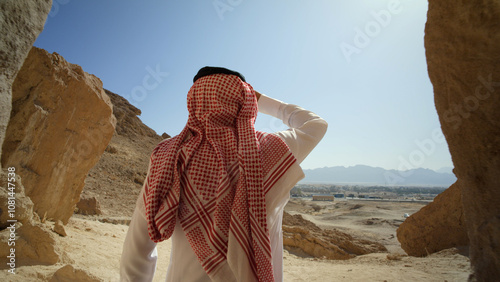Saudi Arabian man staring out at beautiful desert landscape