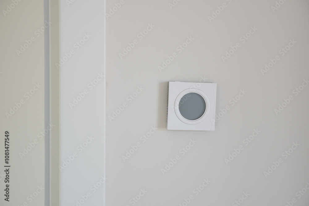 Smart Thermostat on White Wall for Optimal Home Temperature Control Smart Thermostat on White Wall for Optimal Home Temperature Control