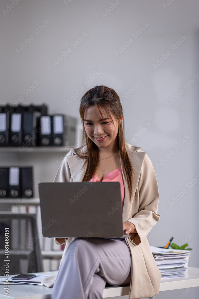 Happy Beautiful asian entrepreneur woman typing on laptop at office work table, looking at camera with toothy smile, posing for professional portrait, enjoying business success, successful job
Happy Beautiful asian entrepreneur woman typing on laptop at office work table, looking at camera with toothy smile, posing for professional portrait, enjoying business success, successful job