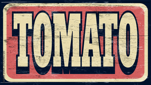 Aged and worn tomato sign on wood