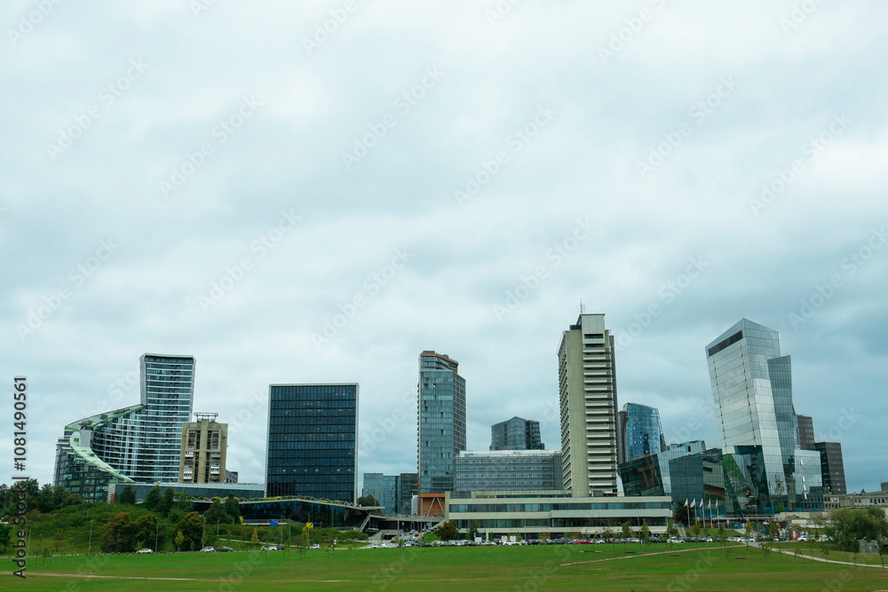 View of modern skyscrapers in city on cloudy day View of modern skyscrapers in city on cloudy day