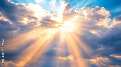 Fototapeta Naklejka Na Ścianę i Meble -  Rays of sunlight breaking through clouds in a dramatic sky 