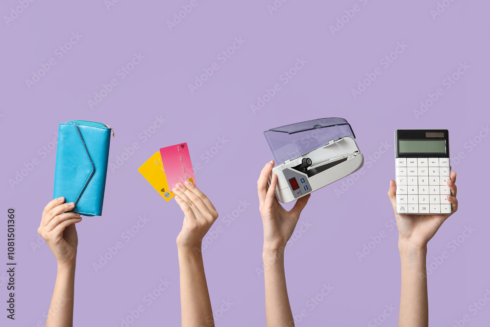 Female hands with wallet, credit cards, cash counting machine and calculator on lilac background, closeup Female hands with wallet, credit cards, cash counting machine and calculator on lilac background, closeup