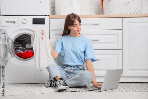 Young woman doing laundry a...
