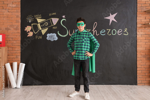 Teenage boy dressed as supe...