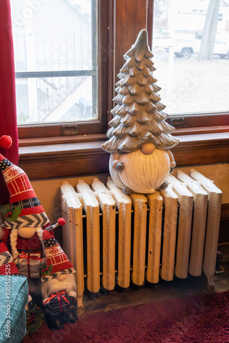 View of an old heating radiator decorated with a cute Christmas gnome
