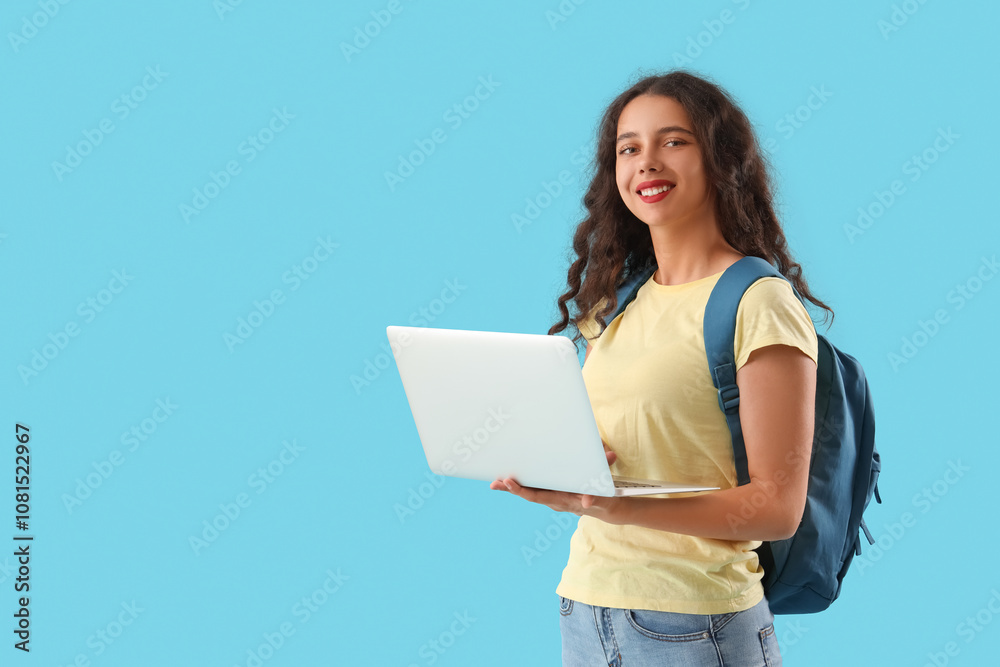 Female student with laptop on blue background Female student with laptop on blue background