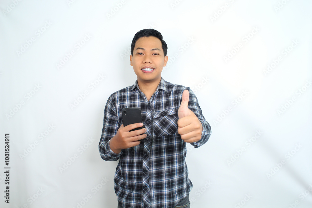 smiling asian man showing thumb up with holding mobile phone wear casual shirt isolated on white smiling asian man showing thumb up with holding mobile phone wear casual shirt isolated on white