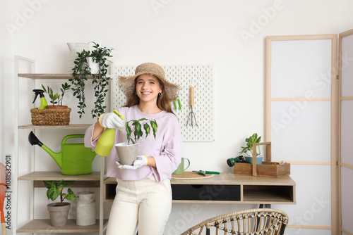 Female gardener spraying ho...
