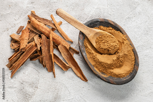 Ground Cinnamon Sticks Wooden Bowl Rustic Background photo